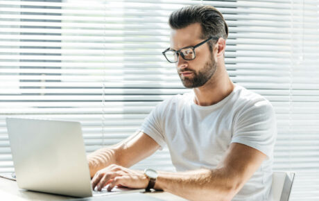 Mann erstellt am Laptop Briefings für Textaufträge